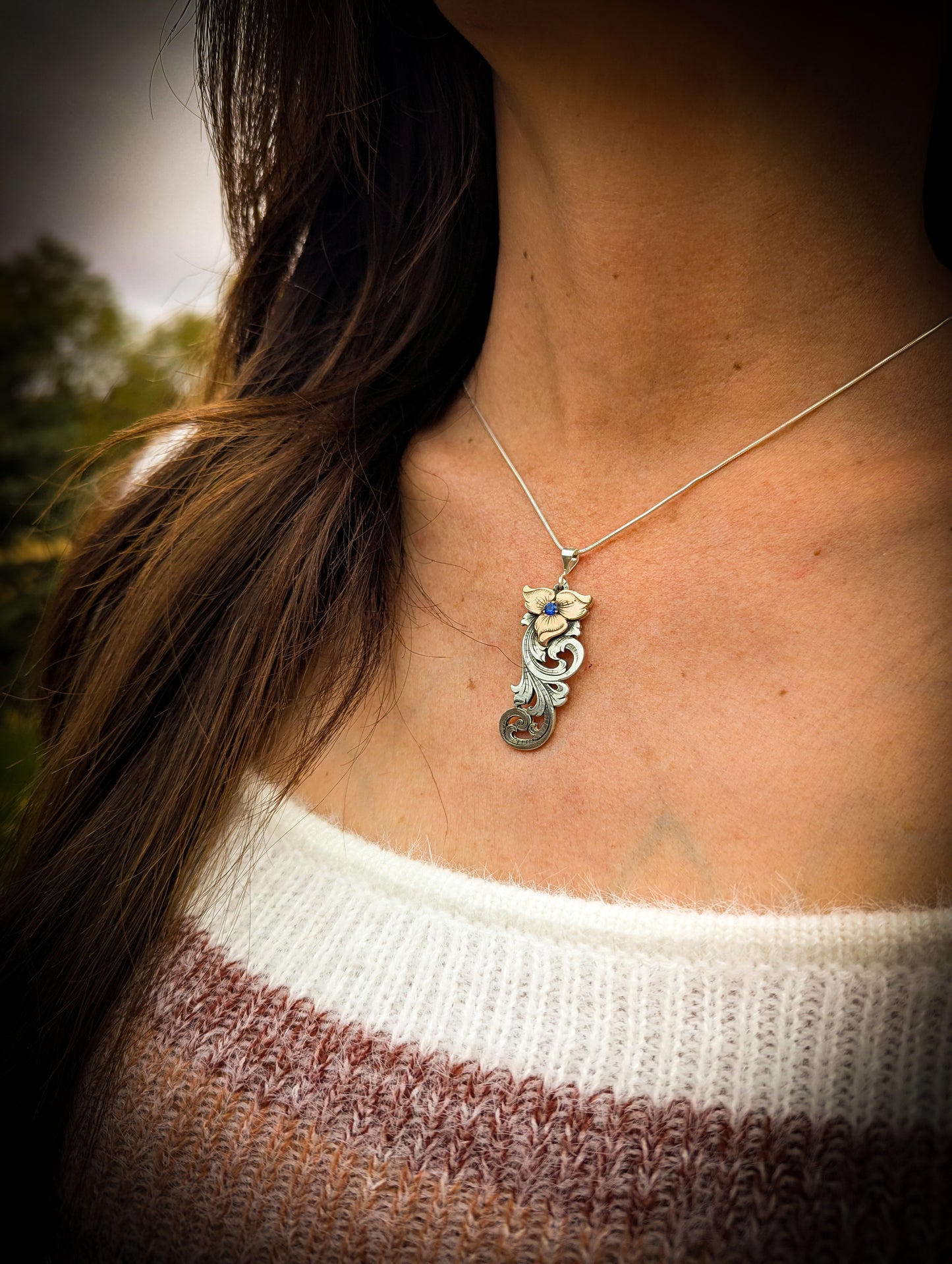 Sterling Silver and Jewelers Bronze Flower Scroll Necklace with simulated sapphire center stone