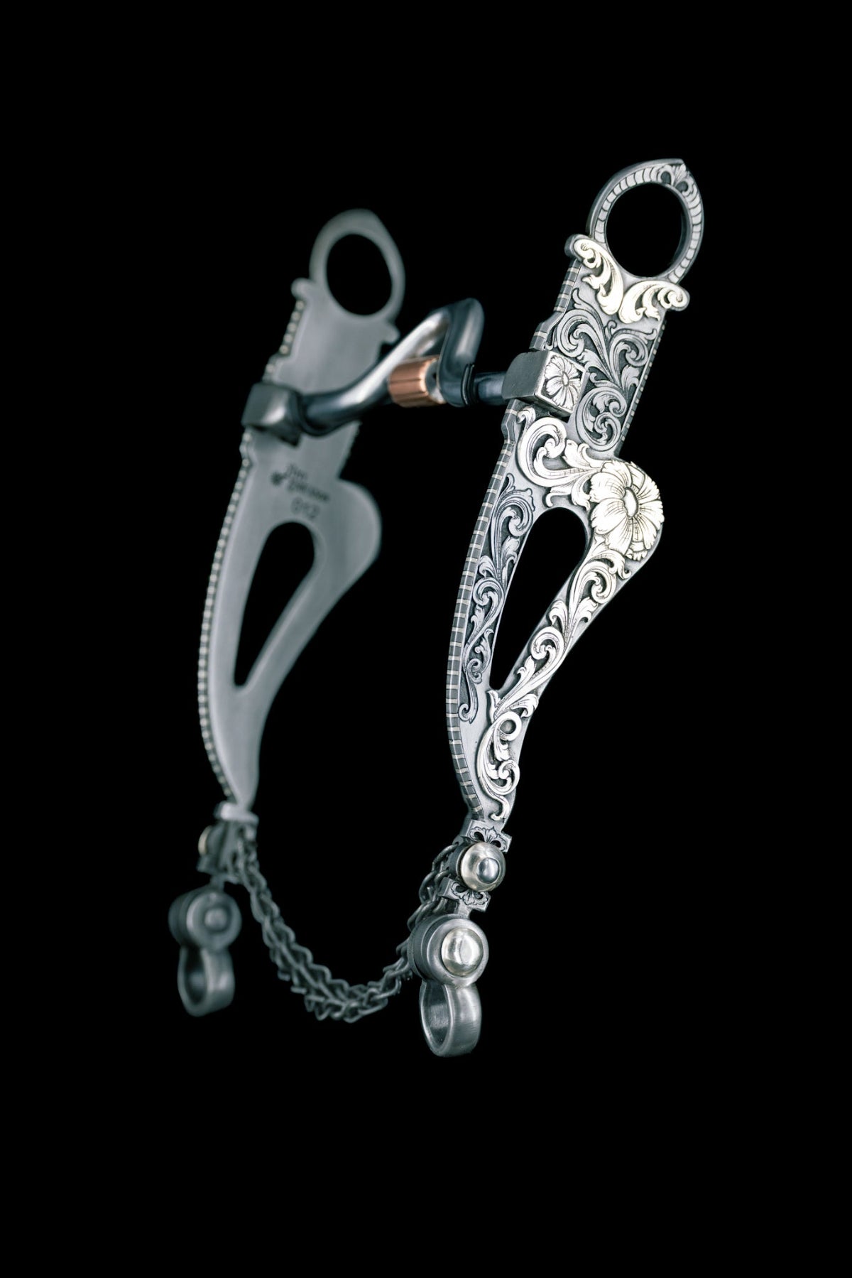 Decorative silver bridle bit on a black background