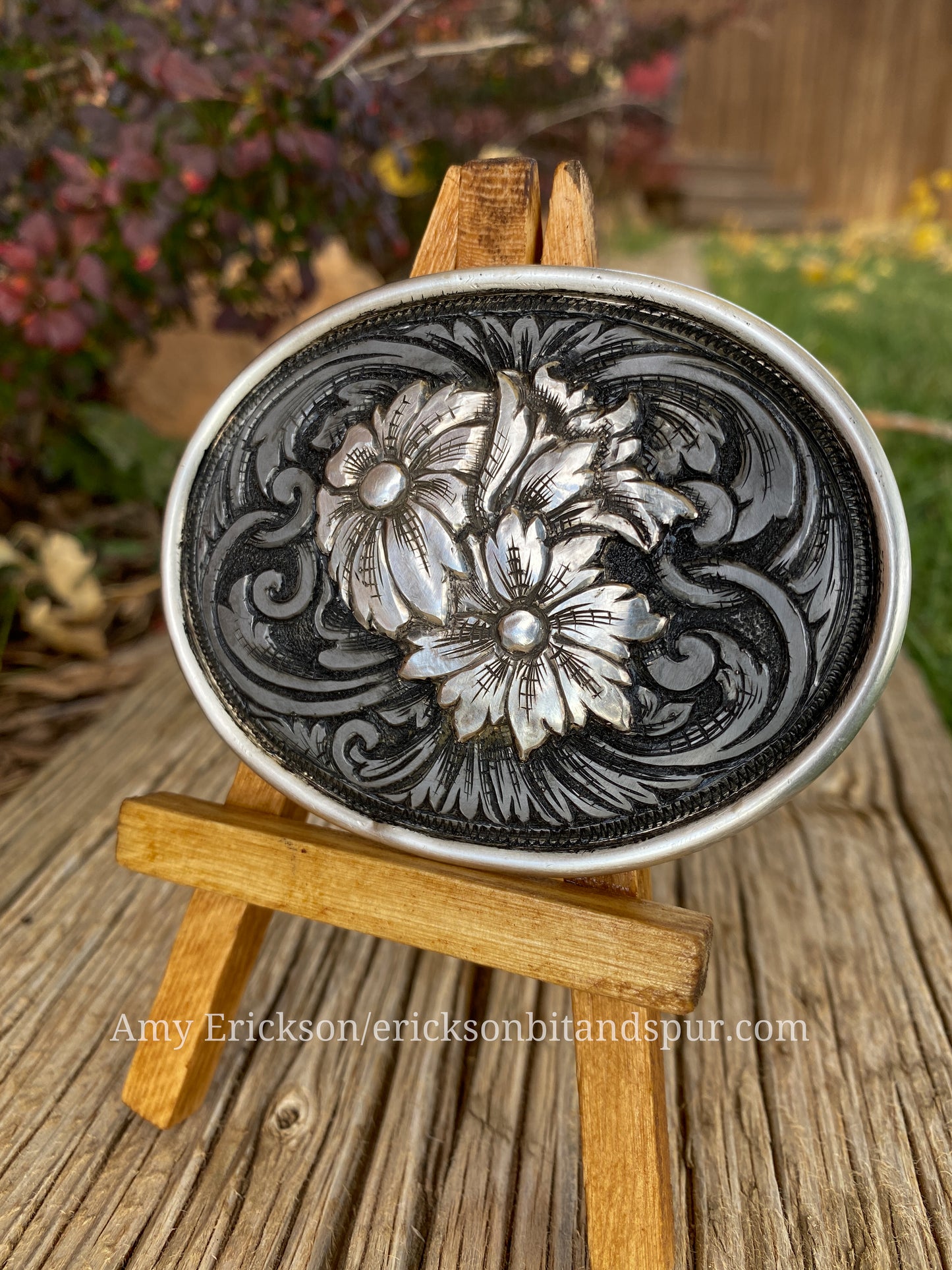 Steel belt buckle with sculpted sterling silver flowers