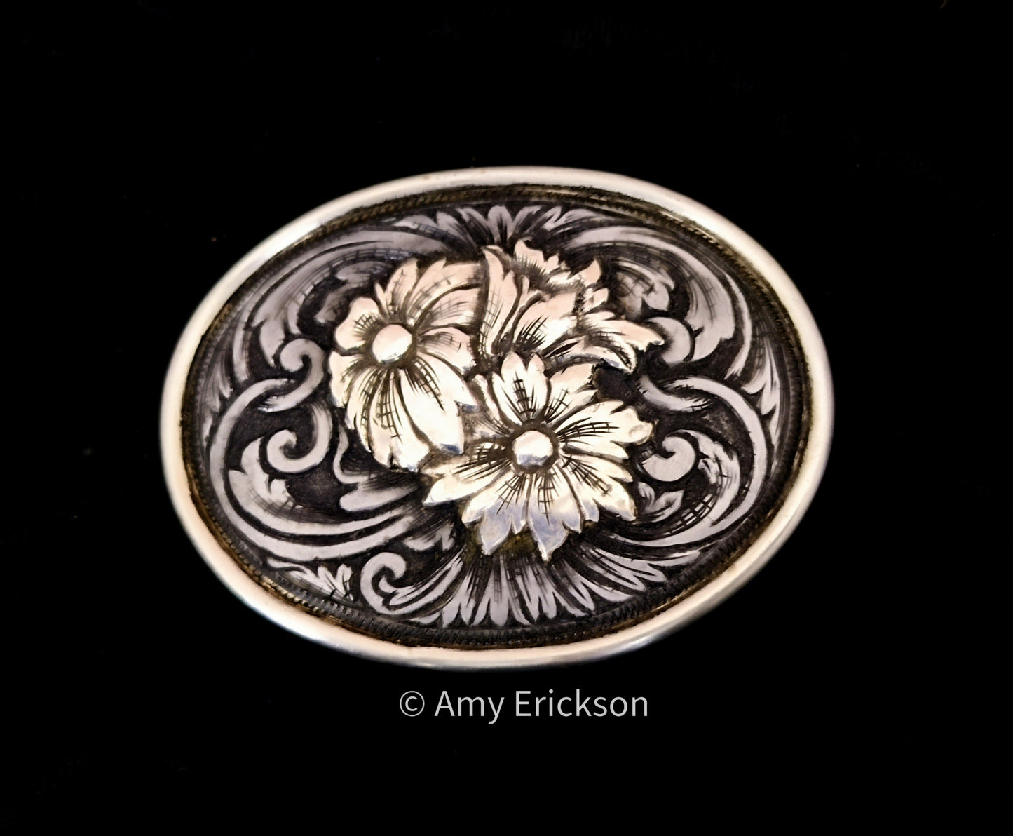 Steel belt buckle with sculpted sterling silver flowers