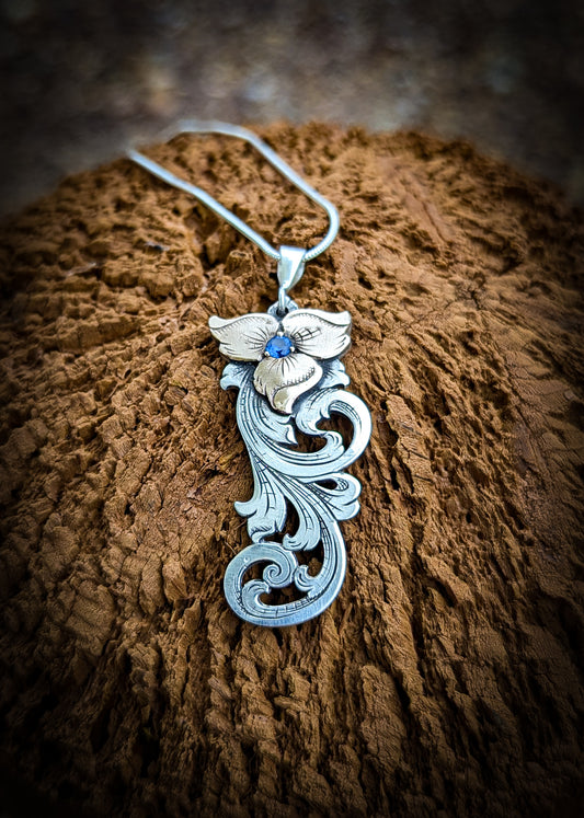 Sterling Silver and Jewelers Bronze Flower Scroll Necklace with simulated sapphire center stone
